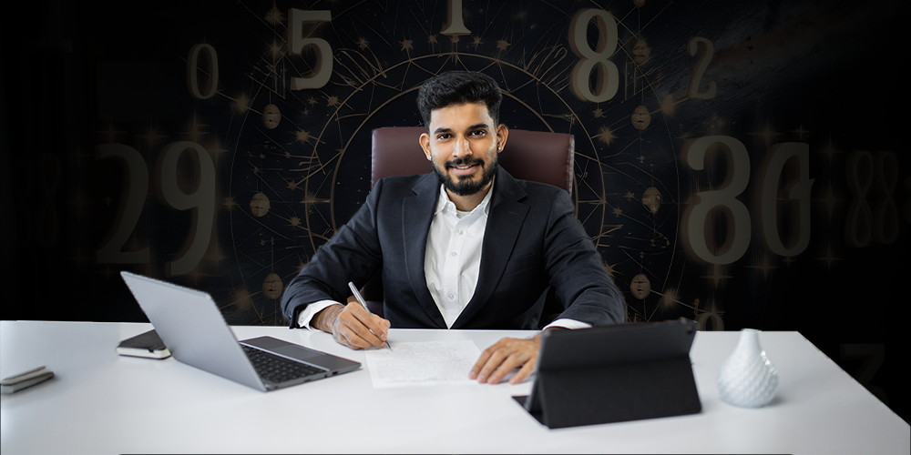 A man in a formal suit sitting at a desk with a laptop and tablet, writing on a document, with a numerology-themed background featuring large numbers.